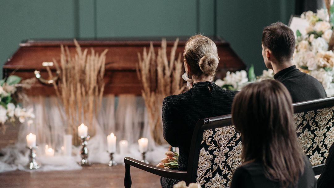 People sitting at a funeral