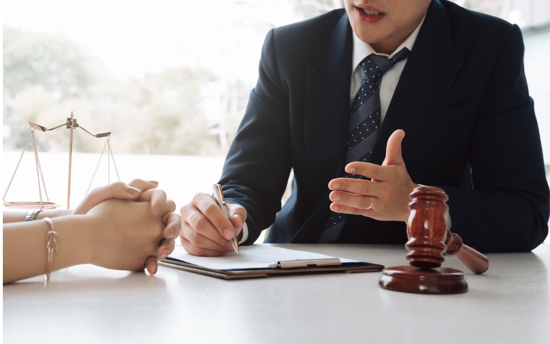 Attorney speaking with client at desk